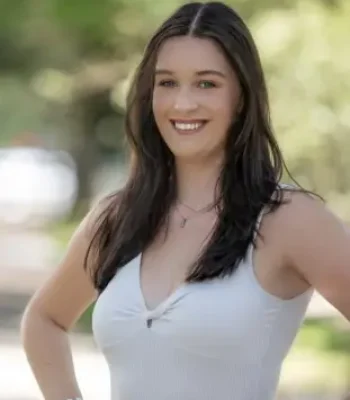 Sadie, Pixel Studio Productions lead photographer, outdoor portrait in a white top