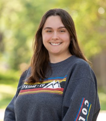 Lily, Pixel Studio Productions team member, outdoor portrait in a gray Keystone Colorado sweatshirt